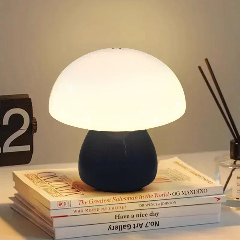 Mushroom-shaped table lamp on a stack of books with a warm glow