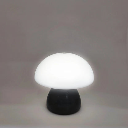 Mushroom-shaped lamp with white shade and black base on a plain background